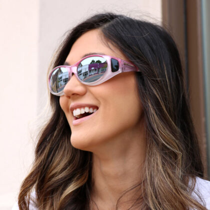 Jess wears her blush cocoons over her regular eye glasses for sun protection.